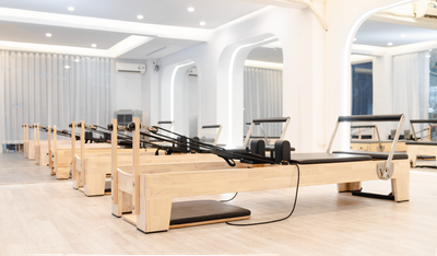 Wooden reformers in a minimalist pilates studio — photo by Lê Đức on Pexels
