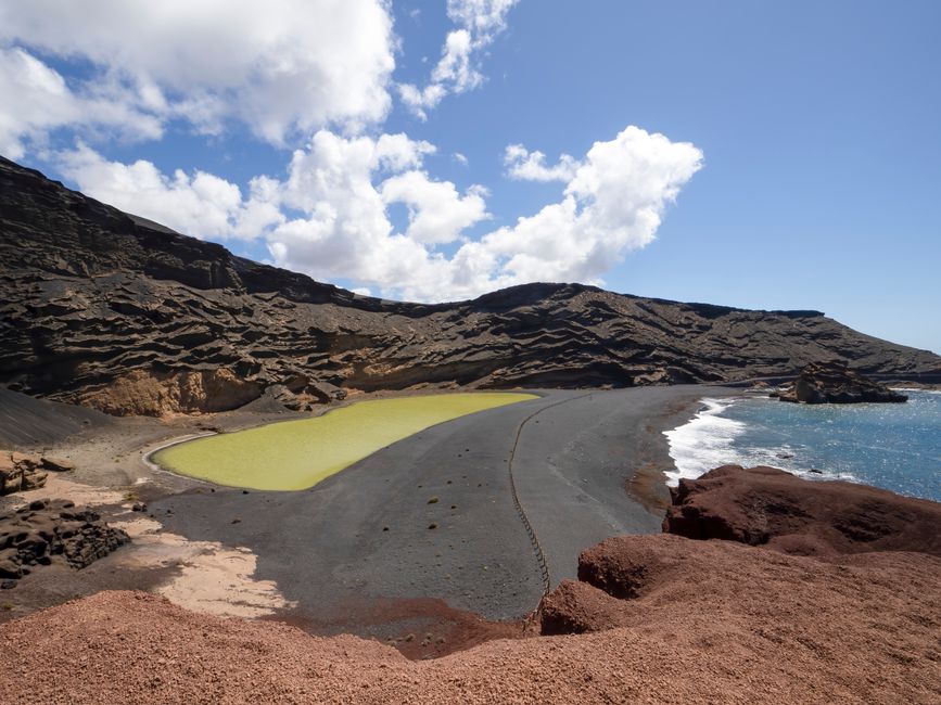 Scenic view of El Golfo's Charco Verde Lagoon and rocky coast in Lanzarote, Spain.