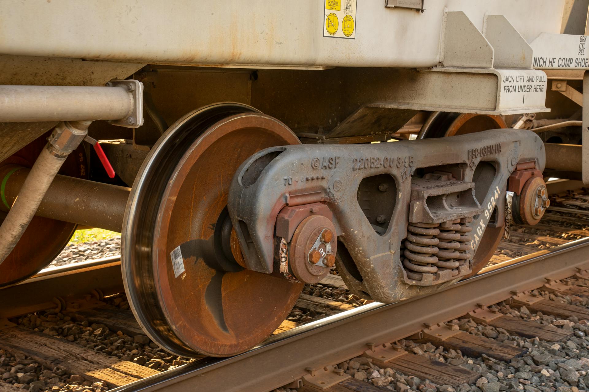 Detailed view of a train wheel and suspension system on railroad tracks in Reads Landing, MN.