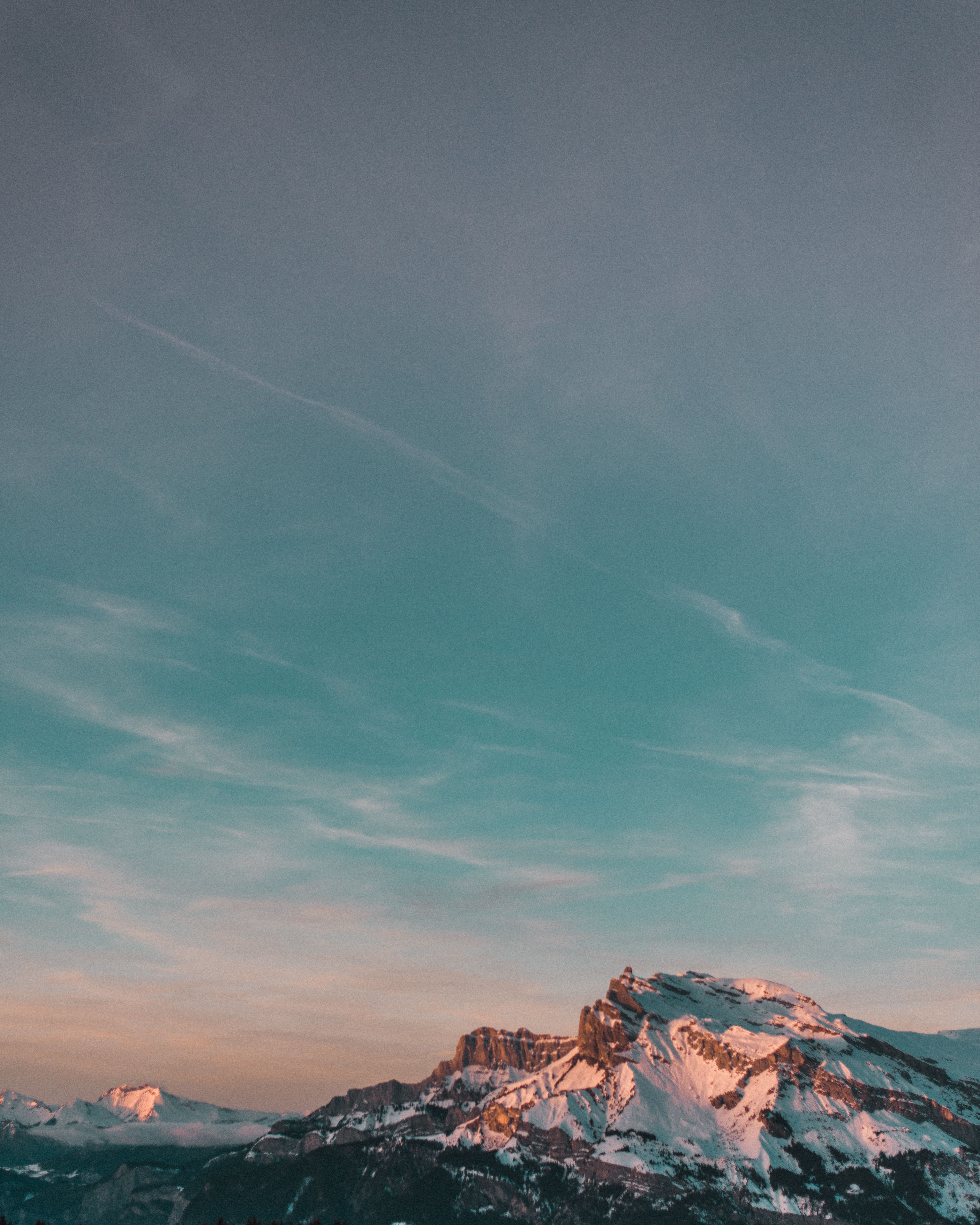 Stunning snow-capped mountain landscape under a serene twilight sky.