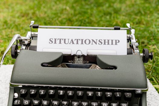 Close-up of a vintage typewriter with the word 'Situationship' typed on paper outdoors.