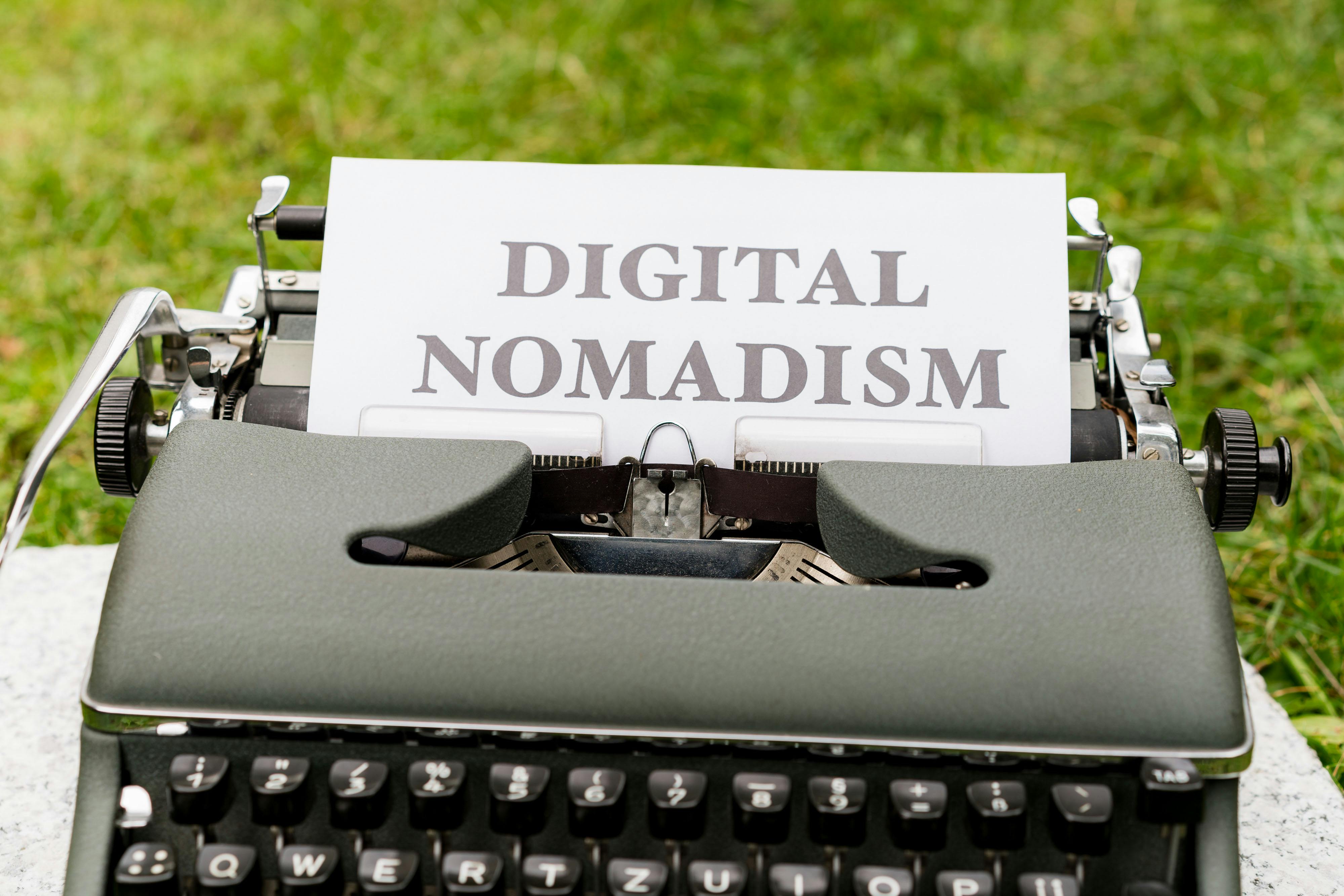 a typewriter with a paper that says digital nomadism