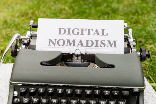 A retro typewriter outdoors with paper showing 'Digital Nomadism,' symbolizing flexible work and lifestyle.