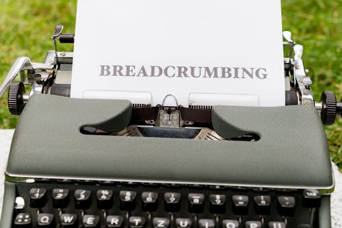 A typewriter with a paper that says breadcrumbing