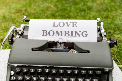 A typewriter with the words love bombing written on it