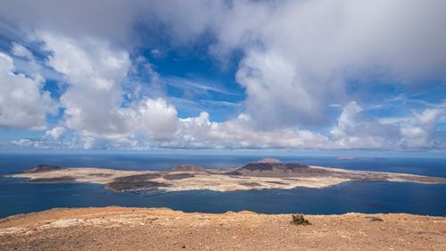 Free A breathtaking aerial view of an archipelago under a vibrant blue sky and scattered clouds. Stock Photo