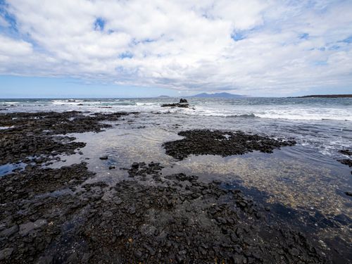 Free Explore the dramatic volcanic rock formations along this beautiful coastal seashore. Stock Photo