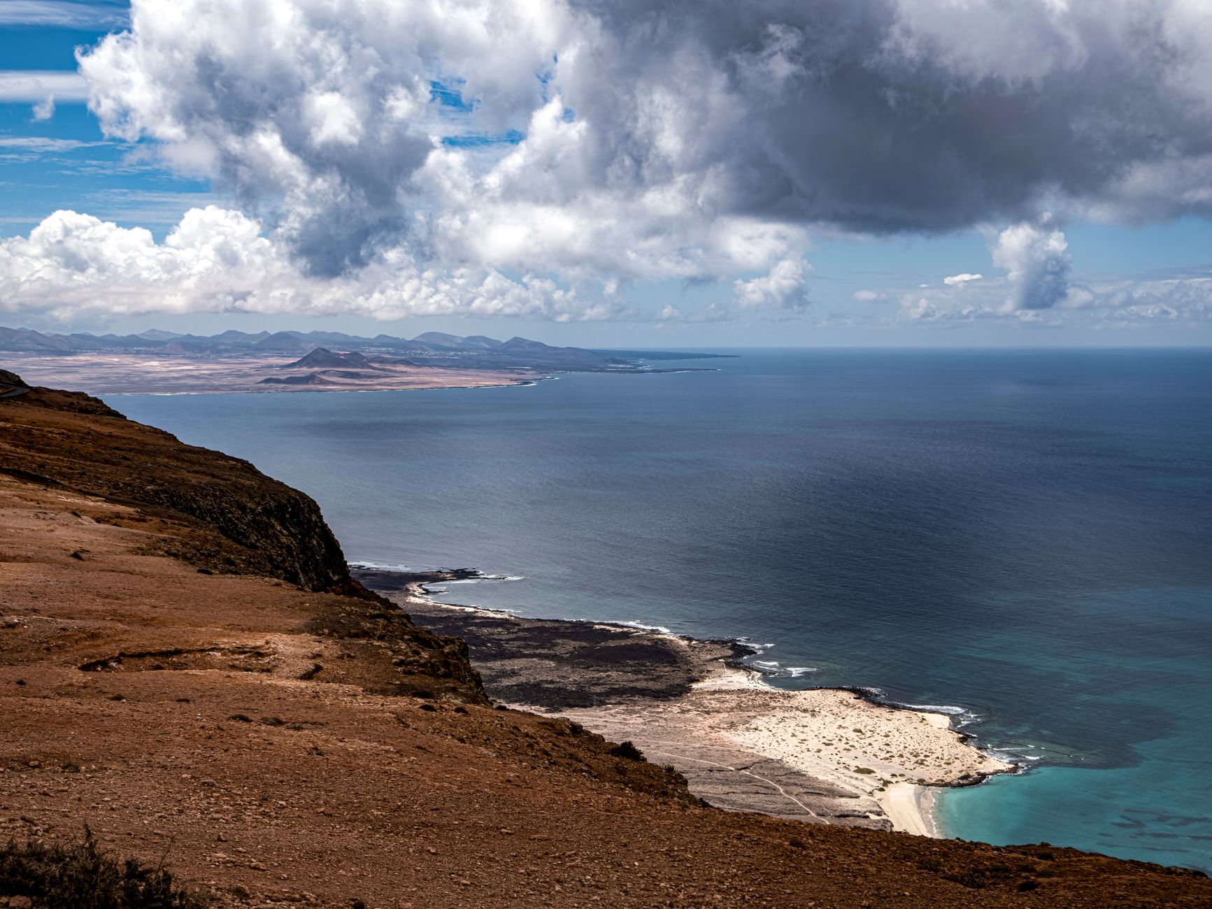 Breathtaking coastal scenery of the Canary Islands showcasing mountain, sea, and sky.