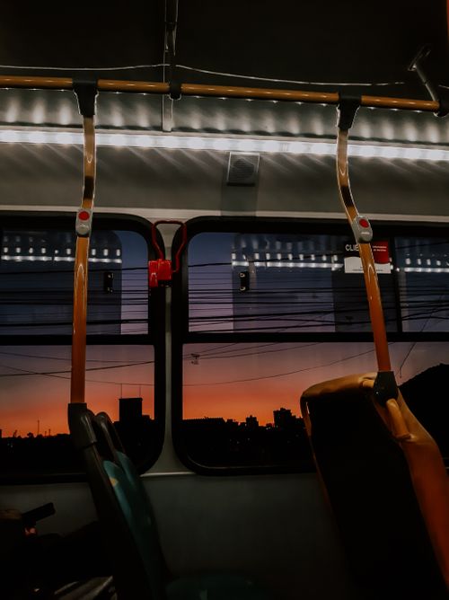 Free View of a city skyline silhouette from inside a tram during sunset, showcasing urban life. Stock Photo