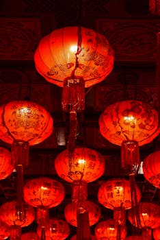 Traditional Chinese lanterns glowing in a festive display in Bangkok, Thailand.