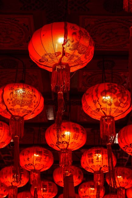 Traditional Chinese lanterns glowing in a festive display in Bangkok, Thailand.
