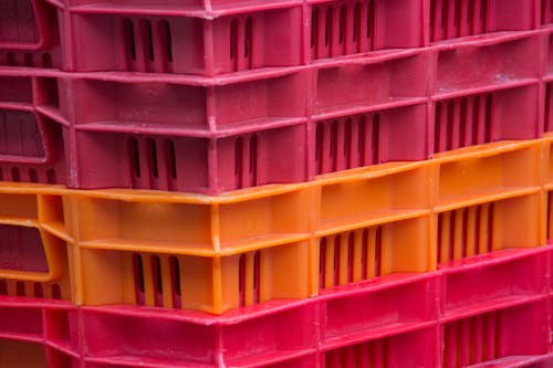 Close-up of a Stack of Pink and Orange Plastic Containers