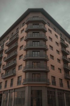 Contemporary apartment building featuring multiple balconies and a distinct architectural design.