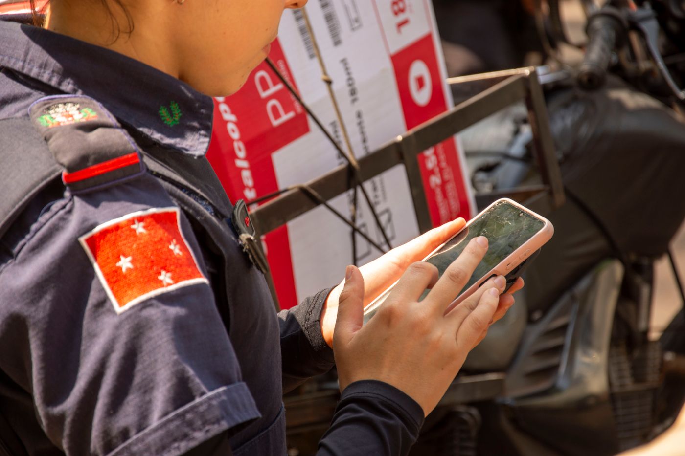 Police officer holding a smartphone during an official property review