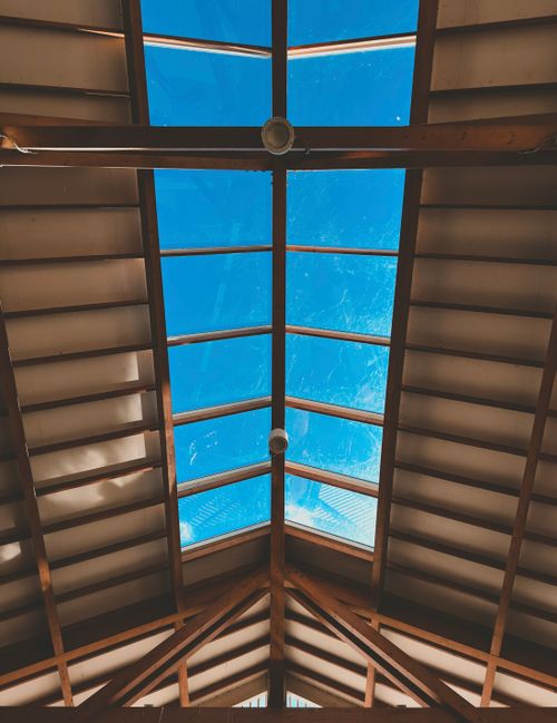 Free Captivating view of a skylight ceiling capturing clear blue sky from a Zaandam building's interior. Stock Photo