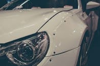 在德国埃森车展上，一辆白色跑车展示了车头灯和挡泥板的详细视图