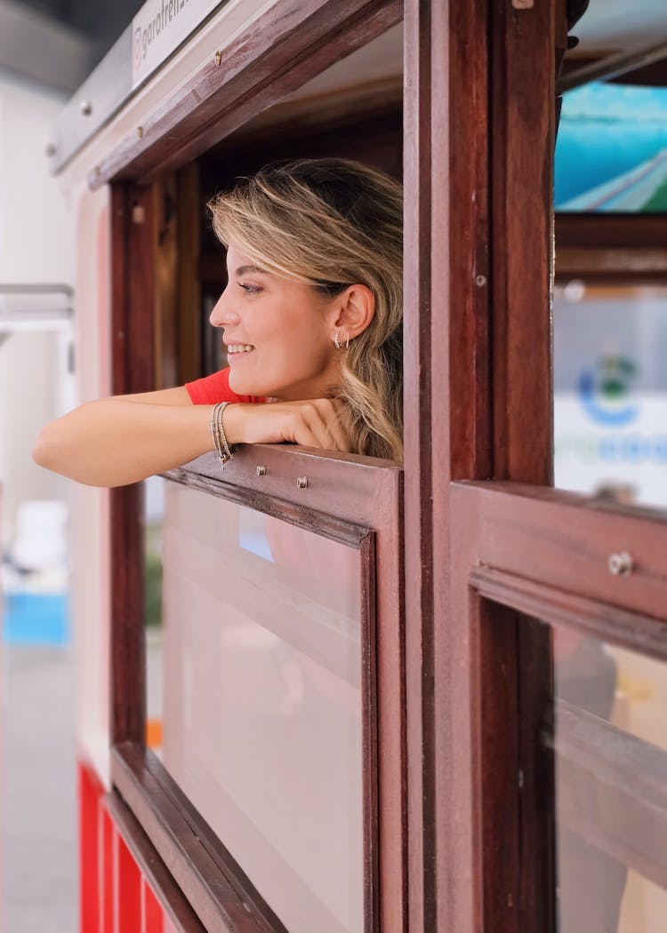 Smiling Woman Looking Out Of Window