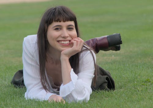 Free Young Woman Lying on the Grass and Smiling  Stock Photo