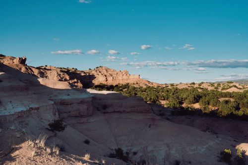 Free A breathtaking view of desert landscape with sandstone formations and clear blue sky. Stock Photo