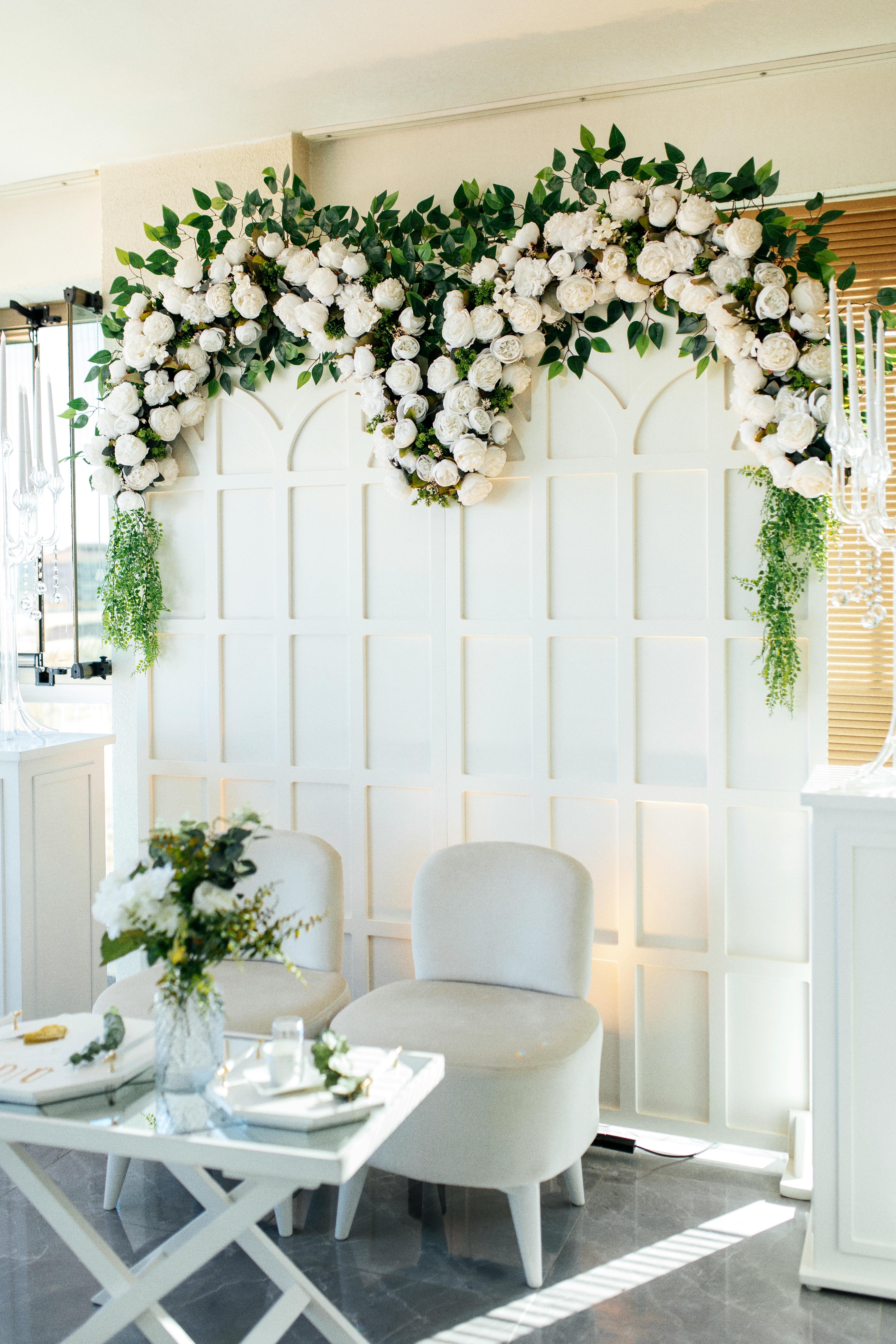 Chic wedding setup featuring lush floral arch and elegant seating for intimate gatherings.