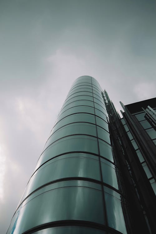 Glass Tower of a Modern Building Against the Cloudy Sky