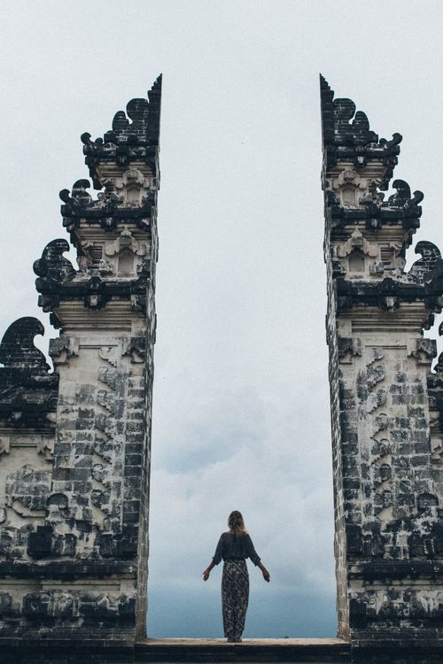 Free A traveler stands between the iconic split gateway of Candi Bentar in Bali, Indonesia. Stock Photo