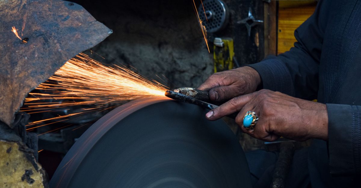 Using Grfinder Close-up of a Man Using a Grinder in a Workshop · Free Stock Photo