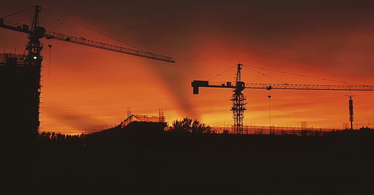 Construction crane over Toronto housing, rising building costs and demand