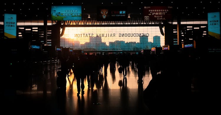 Silhouettes Of People At Railway Station