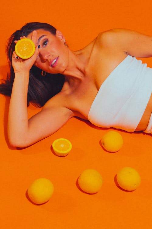 Woman Lying Down with Oranges