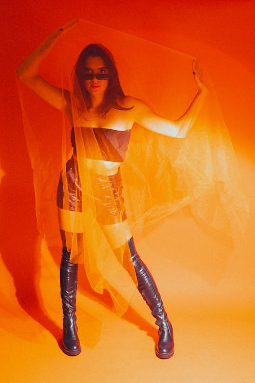 A Woman in Latex Clothing on an Orange Background