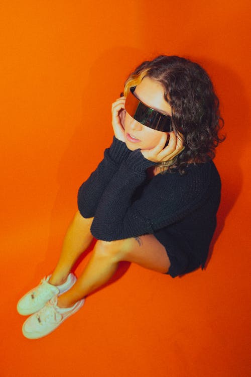 Studio Shot of a Young Woman Wearing Modern Sunglasses 