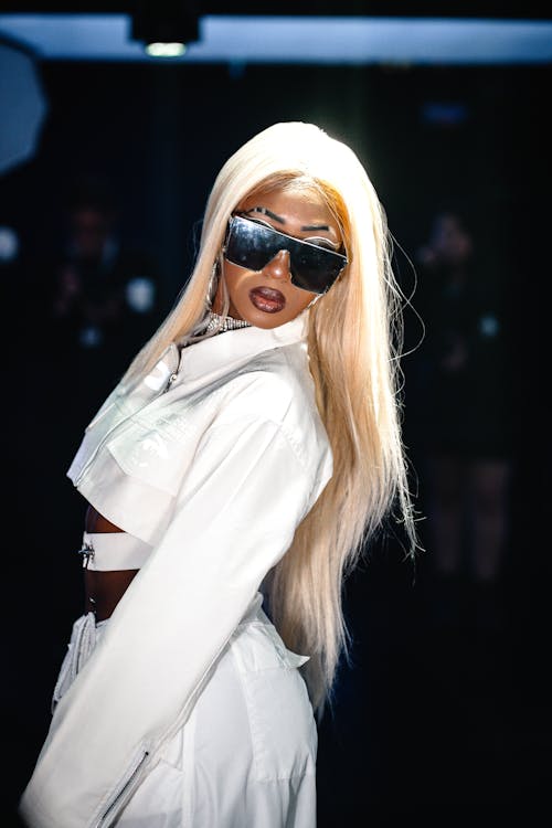 Young Woman in a Modern White Outfit and Sunglasses