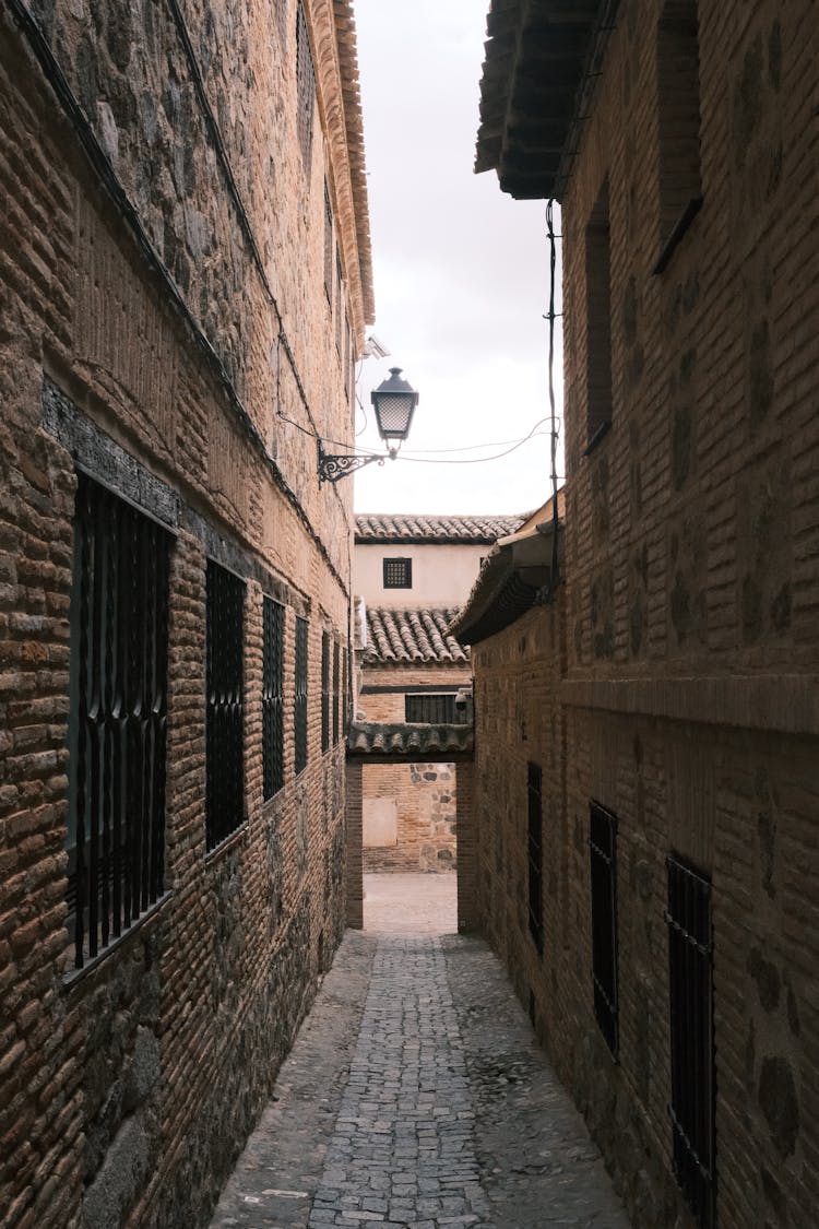 Narrow Alley Among Stone Houses In Old Town