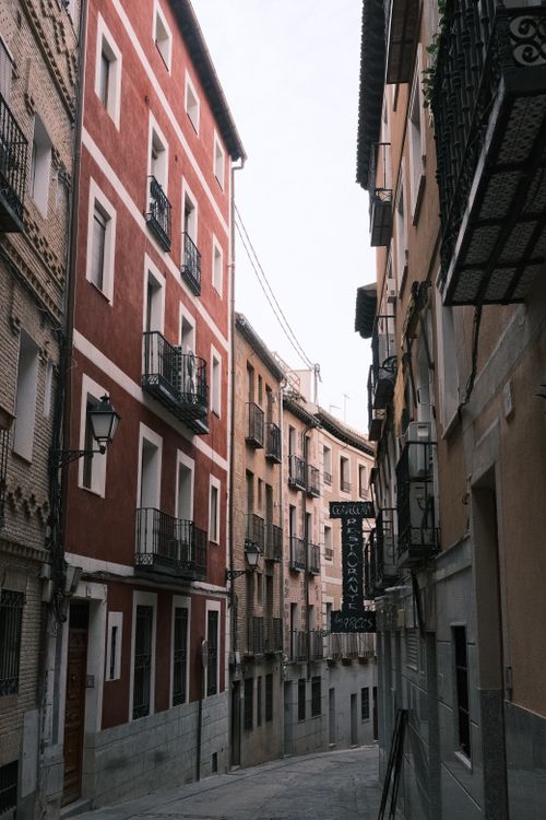 Free Explore a picturesque narrow street lined with traditional buildings in Spain's historic urban center. Stock Photo