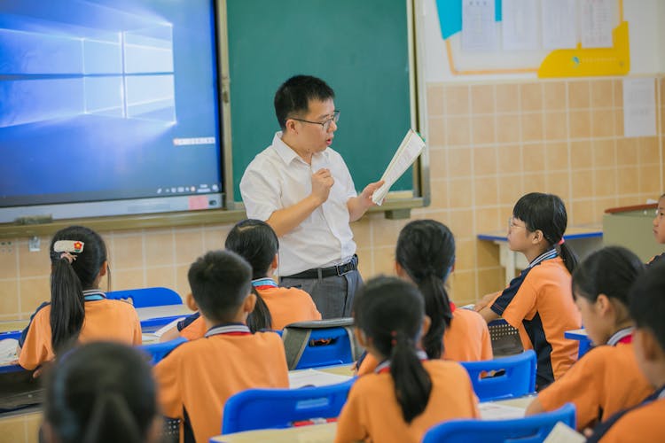 Teacher And Children In Classroom