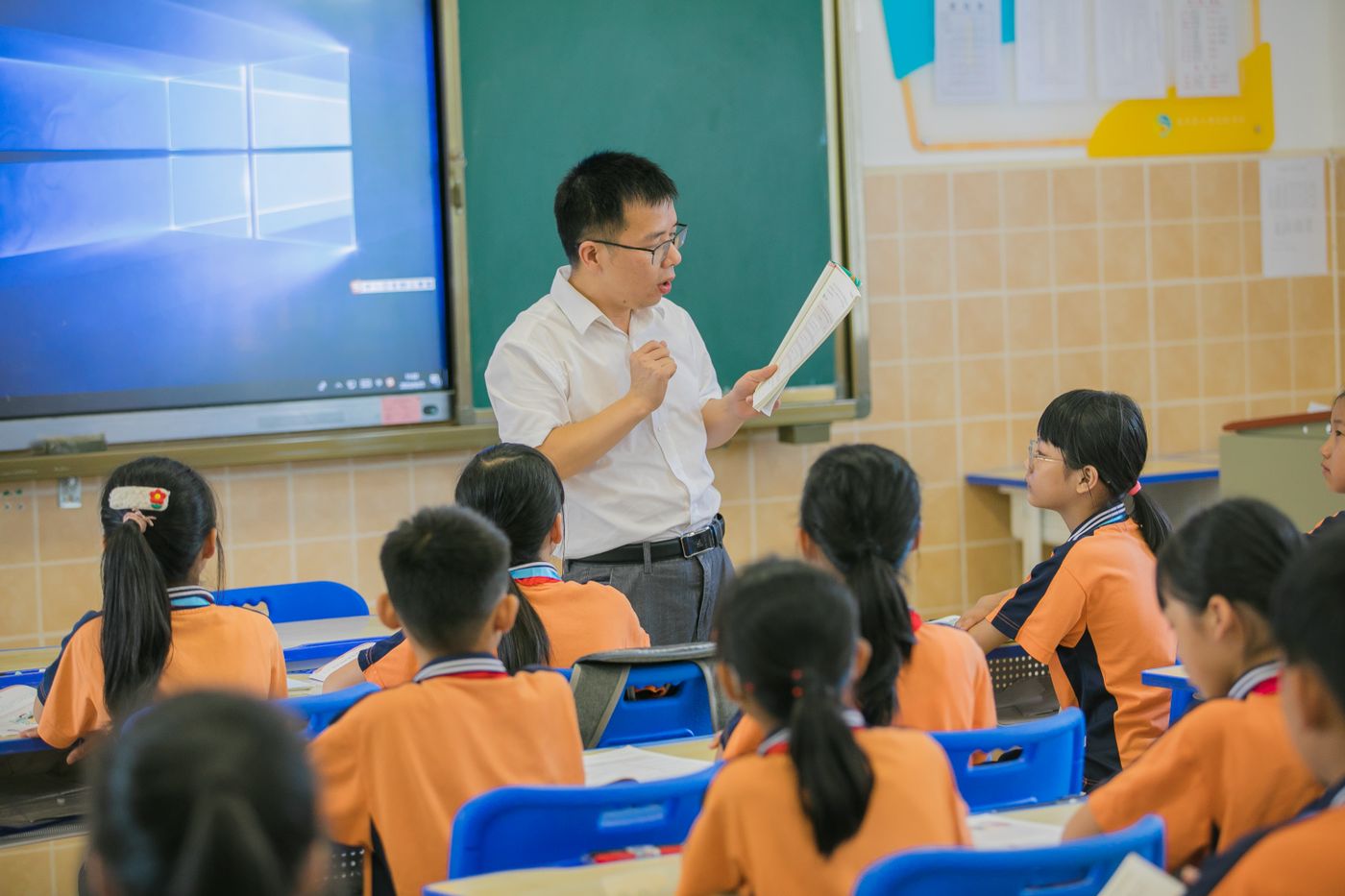 Teacher working with a small group of students in a classroom setting typical of a gap year teaching abroad placement