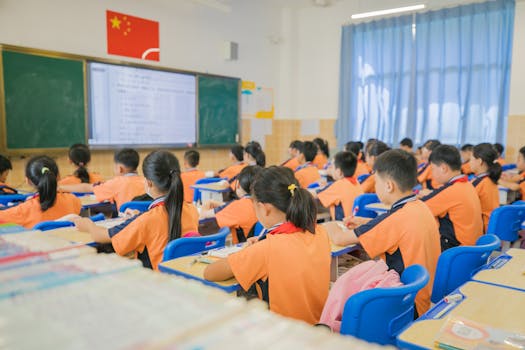 Children attentively listening in a classroom setting, showcasing focused learning in a school environment.