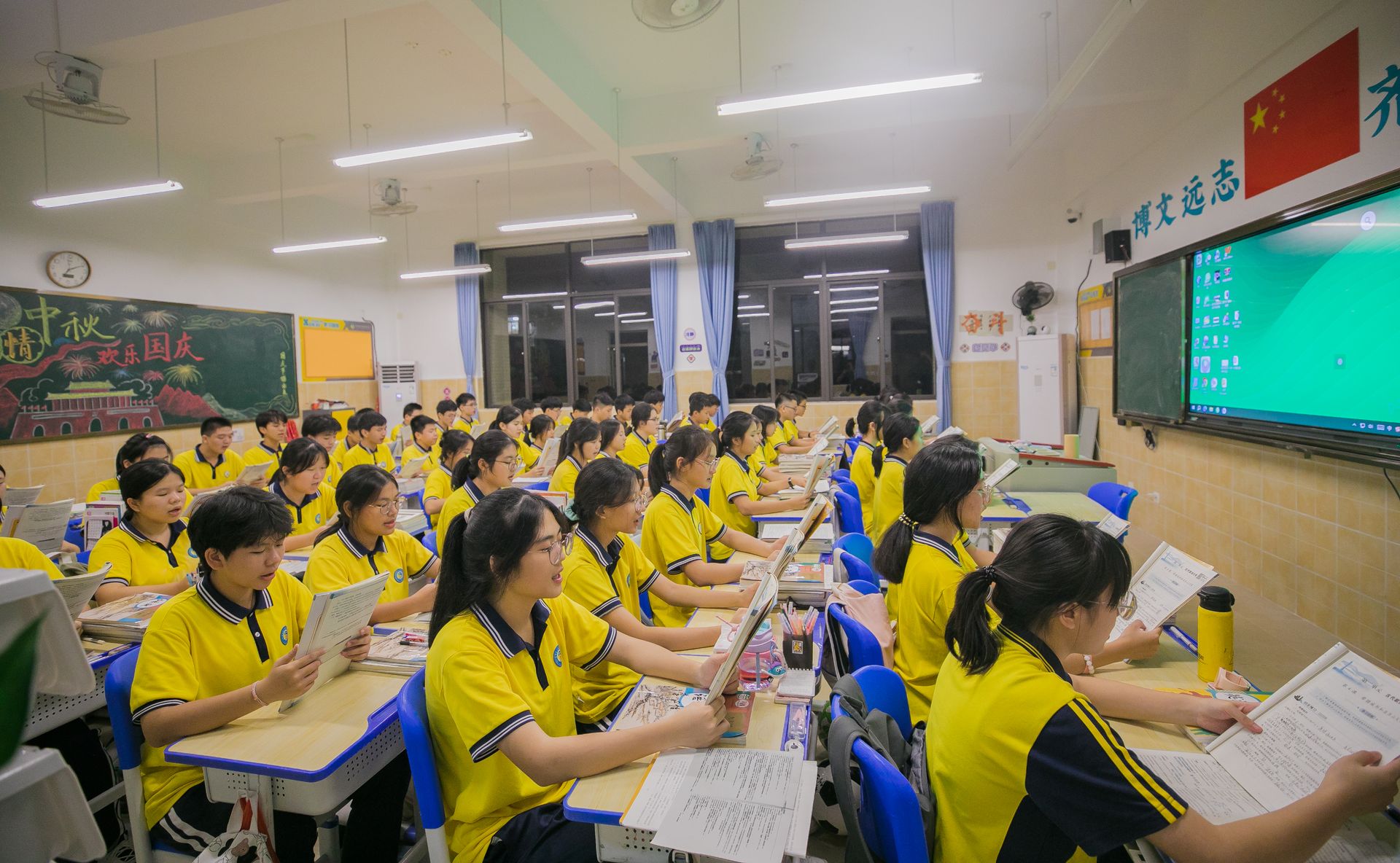 Asian students in a classroom engaged in learning with a teacher, focusing on education and collaboration.