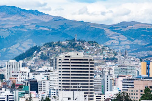 Free Cityscape with Modern Buildings under a Mountain, Quito, Ecuador Stock Photo