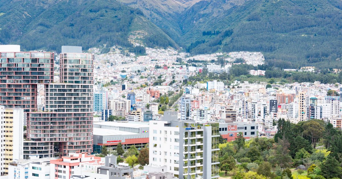 Panoramic view of Quito's modern architecture with a backdrop of the Ecuadorian Andes.
