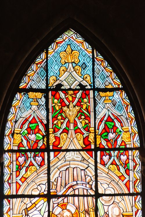 Free Colorful stained glass window showcasing neo-gothic architectural design in a cathedral. Stock Photo