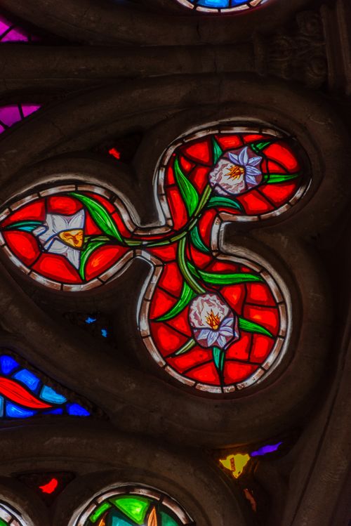 Free Detailed view of intricate stained glass with vibrant colors in a religious context. Stock Photo