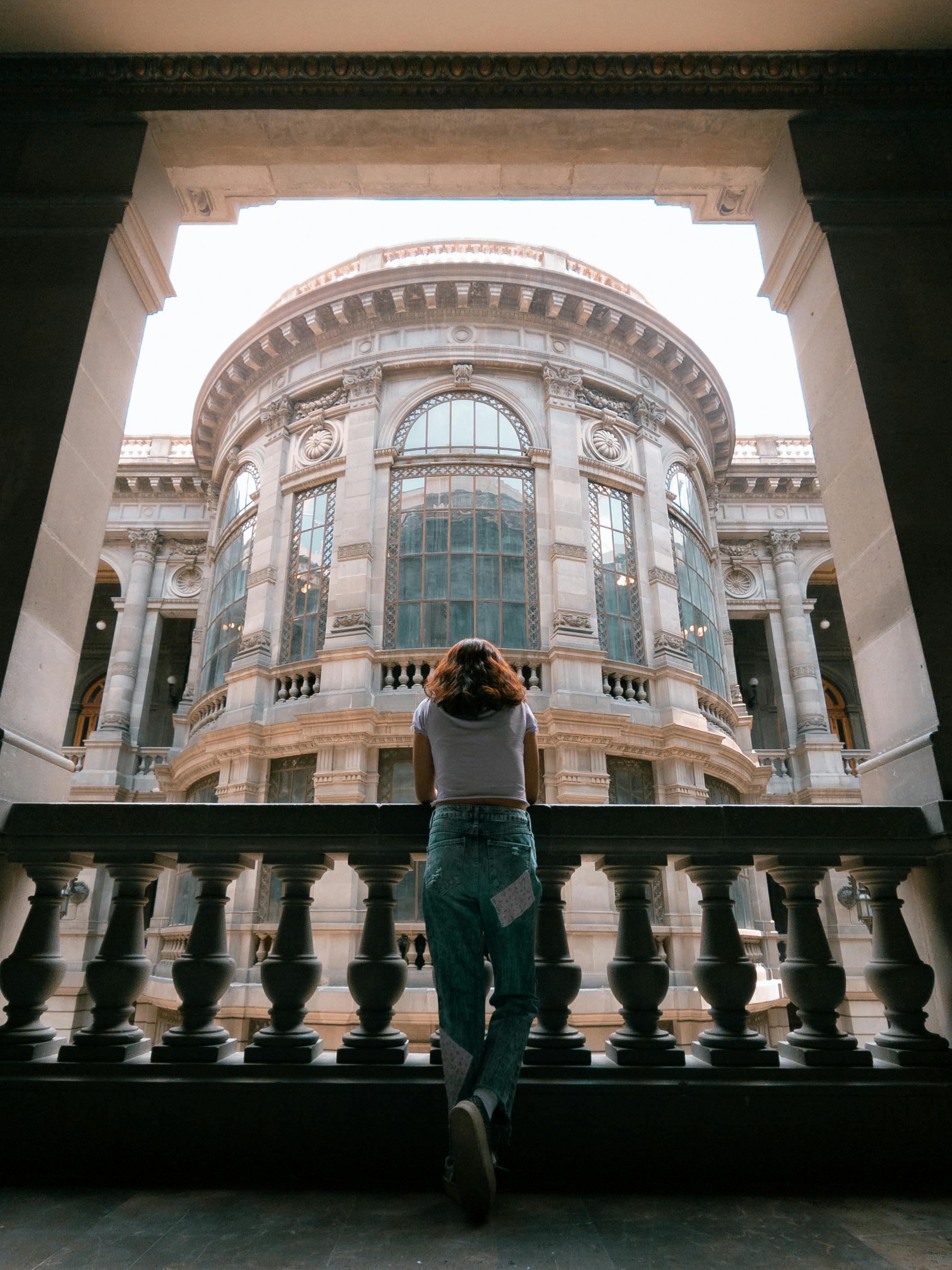 back view of a woman standing by the balustrade in the national museum of art in mexico city mexico