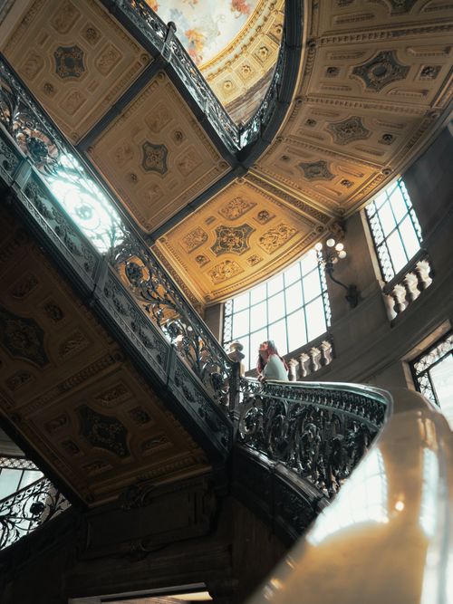 Free Intricate metal staircase and ornate ceiling in Mexican art museum captured in warm light. Stock Photo