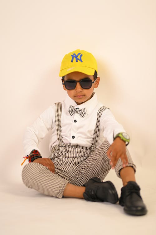 Boy Sitting and Posing in Cap, Sunglasses and Shirt