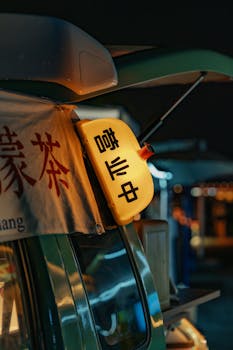 Close-up of a glowing sign at a bustling night market, capturing the lively ambiance.