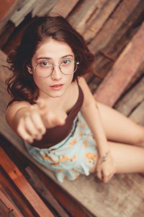 Selective Focus Photography of Woman Pointing Up