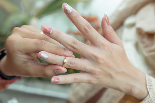 Man Putting Engagement Ring on Woman Hand