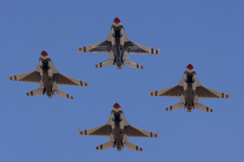Free US Air Force Thunderbirds flying in formation against a clear blue sky. Stock Photo